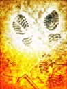 An abstract closeup high angle view of a childÃ¢â¬â¢s dark grey shoe prints on a colourful slate pavement.